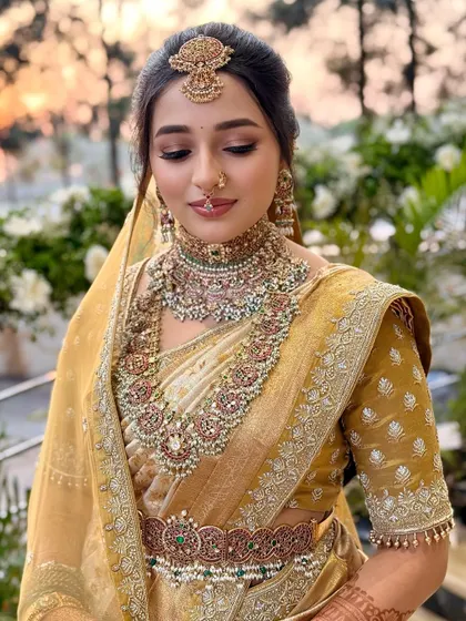 The artistry is in the details. This close-up on Nischaya's makeup highlights the soft, blended eyeshadow and the perfect lip color that completes her traditional look.