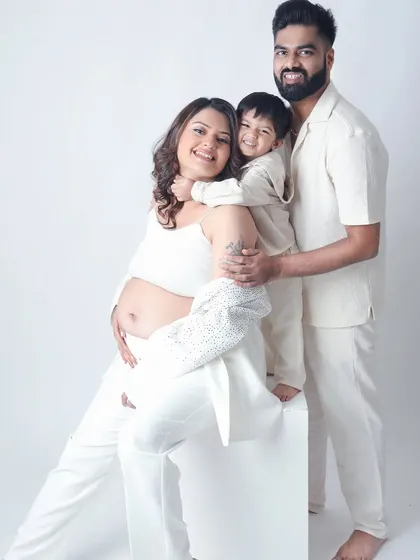 A beautiful maternity session that's also a family portrait. The older sibling gives his mom's baby bump a loving hug, excited to meet the new arrival.