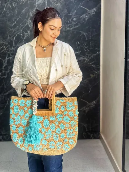 A detail shot of the beautiful blue and natural-toned crochet tote.