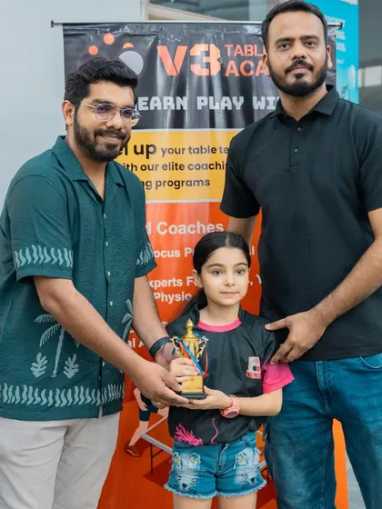 Presenting an award to one of our youngest female competitors. I am dedicated to encouraging girls to participate and excel in table tennis.