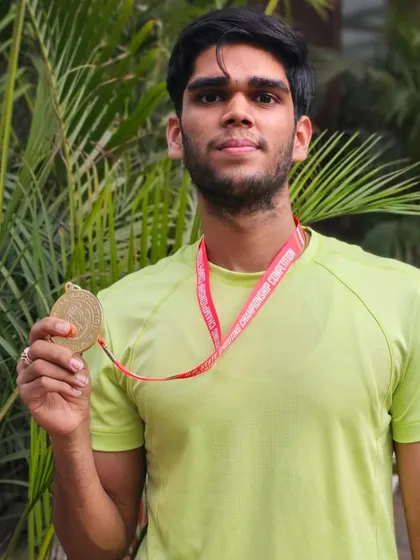 Sanskar Havelia proudly displays his gold medal from the 50M 3 Position event at the UP State Shooting Championships.