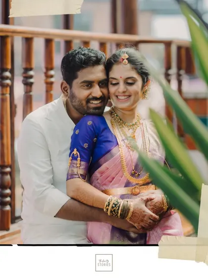A warm and loving embrace between the couple on a balcony, with their joyful smiles telling the whole story.