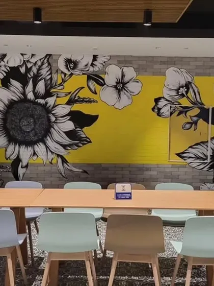 In another part of the Providence cafeteria, we painted this high-contrast mural of monochrome sunflowers against a bright yellow background, bringing a burst of sunshine indoors.