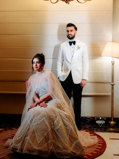 A formal, editorial-style portrait. Her seated pose in the stunning gown, complemented by his confident stance, creates a balanced and powerful image. This showcases my ability to direct more formal, posed shots that still feel authentic.