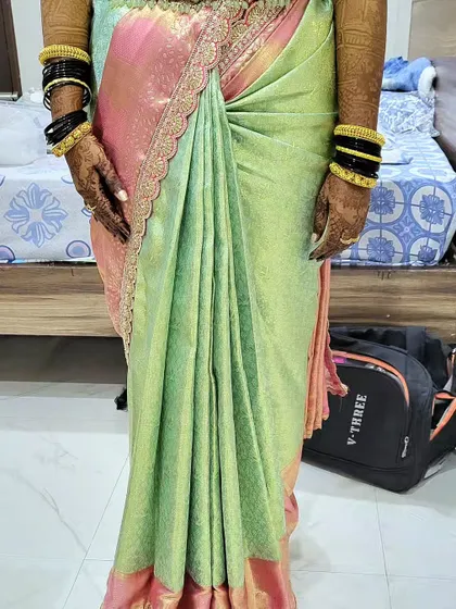 A close-up of the reception saree drape for Lavanya. You can see the neat hip pleats and the way the fabric is tucked to create a flattering, body-hugging fit that lasts all evening.