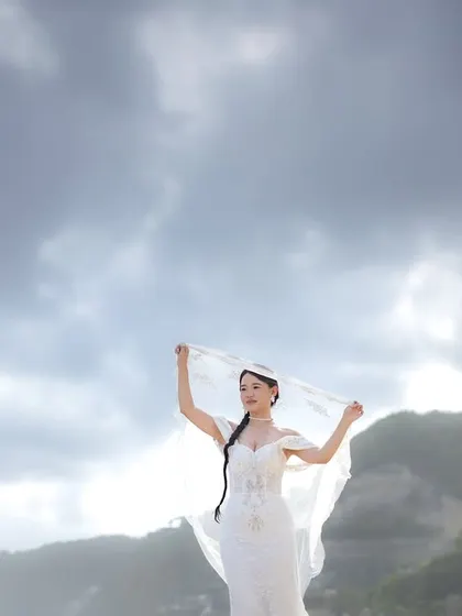 A joyful portrait of the bride, her veil catching the wind on a Bali beach. We focus on both couple portraits and individual shots that capture your personality.