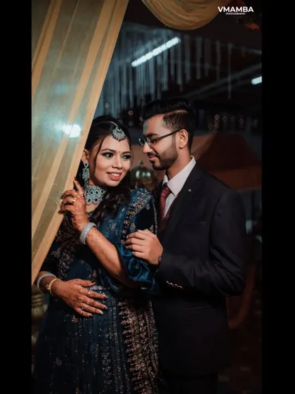 A romantic portrait of a couple at their reception. The soft lighting and their happy expressions create a warm and loving image.