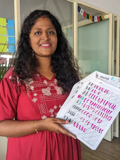 A participant practicing her basic strokes in a brush pen calligraphy workshop.