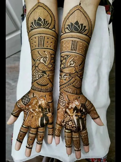 An intimate couple portrait on each palm, framed by beautiful lotus and peacock motifs. This style blends personal portraiture with classic, elegant mehendi patterns.