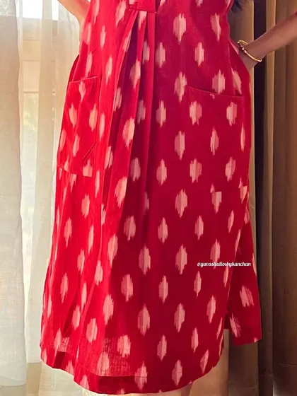 A detailed shot of the pockets and fabric of our bestselling red handloom Ikat dress-cum-kurta.
