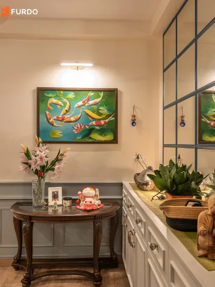 A close-up on the decor elements in the foyer, where a traditional console table is adorned with flowers and collectibles.