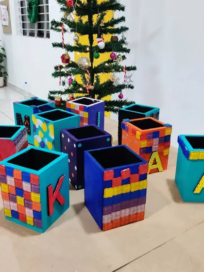 A display of the finished mosaic pen stands in front of a Christmas tree, showing how art can be part of any celebration.