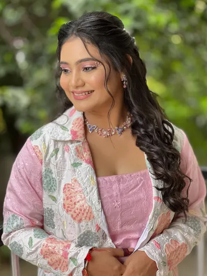 A playful and whimsical look for a carnival-themed event. The makeup has hints of glitter and the hair is styled in soft waves.