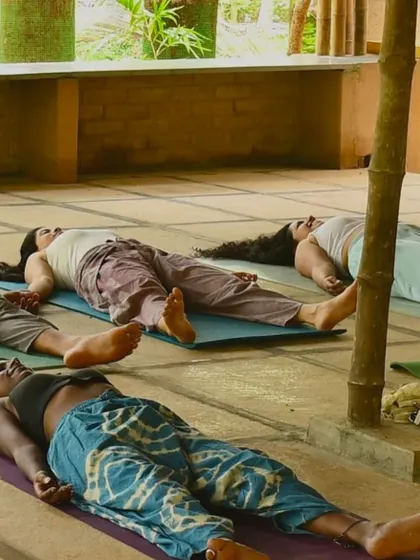 Finding stillness in Savasana. Our yoga pants, seen here in a shibori-style tie-dye and a solid earth tone, are made from soft, breathable fabrics that allow for complete relaxation and freedom of movement.
