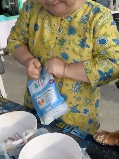 Opening a pack of Chicken Pumpkin Pawer on the go. It's that simple to provide a nutritious meal, no matter where you are.