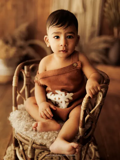 A calm and soulful portrait of a baby boy in a rustic rattan chair. Even in quiet moments, their personality shines through.