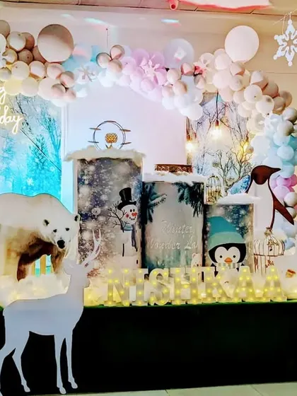 Our winter wonderland theme is filled with charming details. This setup includes a life-like polar bear prop, white reindeer, and sparkling tree branches to create a truly magical arctic scene.