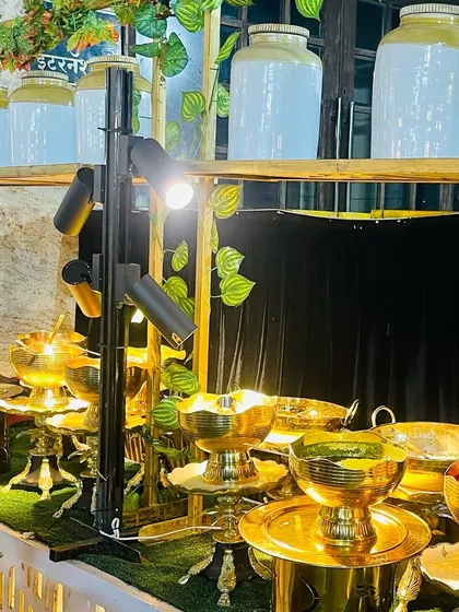 Our salad station gets a touch of gold. The use of gleaming brass serving bowls and traditional Indian pickle jars (barnis) as decor creates a look that is both rustic and regal.