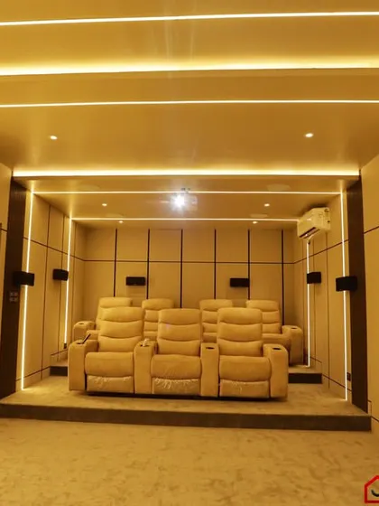A wide shot of the room, showing the full scope of the design, including the multiple rows of seating and the integrated lighting.