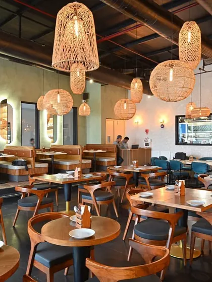 An alternate view of the dining space, showing the cohesive flow between different seating zones. The arrangement of tables and booths was carefully planned to maximize capacity without sacrificing guest comfort or the feeling of spaciousness.