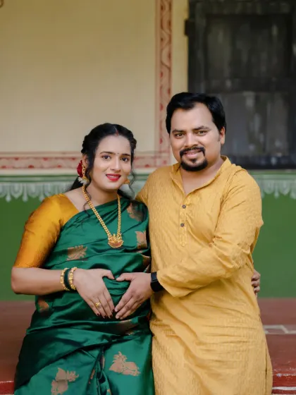 Making a heart on the baby bump is a classic for a reason. It's a sweet, simple gesture of love, beautifully captured in this traditional outdoor maternity photo.