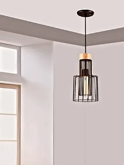 This metal hanging light features a black cage design with a wooden accent. The industrial-inspired aesthetic is perfect for adding a touch of modern, rustic charm to your kitchen or dining area.