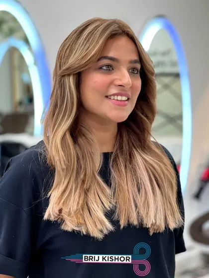 The light catches the beautiful pastel tones in this creamy peach ash blonde balayage. It's a truly unique and eye-catching color.