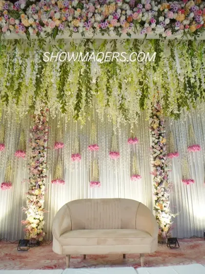 This magnificent stage setup for a Roka ceremony showcases our expertise in floral design. A canopy of hanging wisteria and a lush floral border create a romantic and enchanting backdrop, perfect for capturing beautiful moments. We specialize in creating these large-scale floral masterpieces.