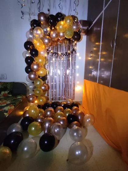 A full view of a birthday arch decoration I set up in a room corner. The floor is covered with balloons, making the entire space feel like a party zone.