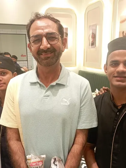 Another photo of umpire Anil Chaudhary with our team. We are glad he enjoyed his meal.