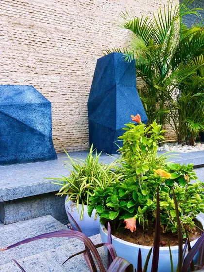 A detail shot of the unique, geometric planters that serve as sculptural art pieces at the entrance.