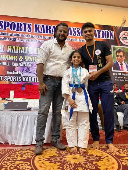 One of our dedicated young students with her well-earned bronze medals from the state championship, a testament to her hard work and fighting spirit.