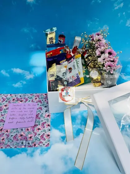 A chocolate lover's dream box for just ₹1000. This hamper is packed with a variety of chocolates and includes a mini floral bouquet and a personal note.