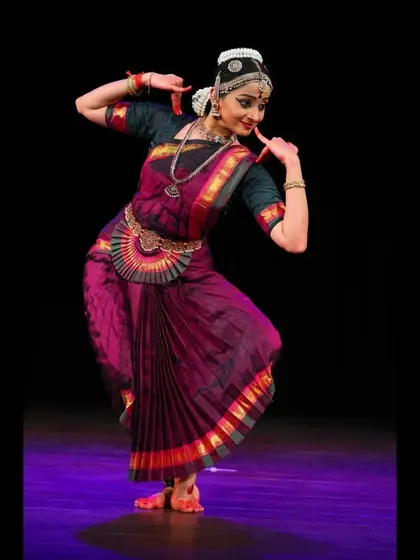 A graceful pose from a traditional recital, showing the beautiful lines and form of the dance.