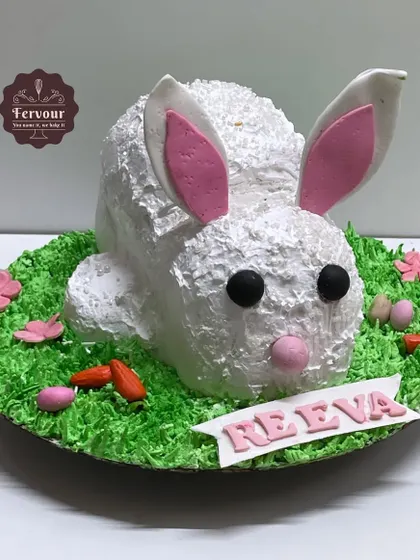 A 3D sculpted rabbit cake, perfect for an animal lover's birthday. The bunny's fur is textured whipped cream, with only the ears and facial features made from fondant.