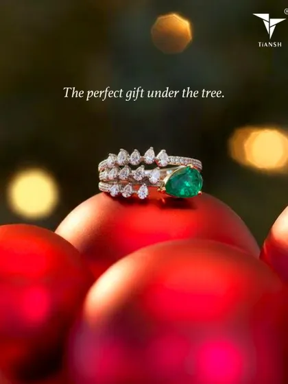 The perfect gift under the tree. This stunning emerald and diamond ring, resting on a Christmas ornament, is a gift that will be worn for a lifetime.