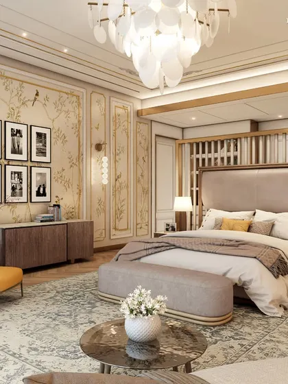 This Parisian-style primary suite is a haven of elegance and comfort. It features hand-painted wallpaper, intricate ceiling mouldings, and a stunning chandelier, complemented by brass and gold accents that sparkle with understated luxury.