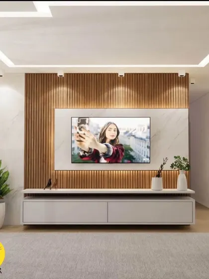 This TV unit design uses a combination of a marble-style laminate and vertical wood fluting for a modern and textured look. The floating console keeps the floor clear, making the room feel more spacious.