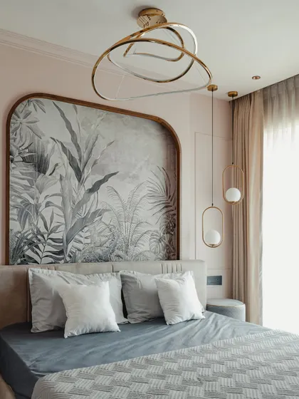 This bedroom is a study in soft elegance. I used a custom-framed botanical wallpaper as a headboard, complemented by delicate pendant lights and a blush pink color scheme.