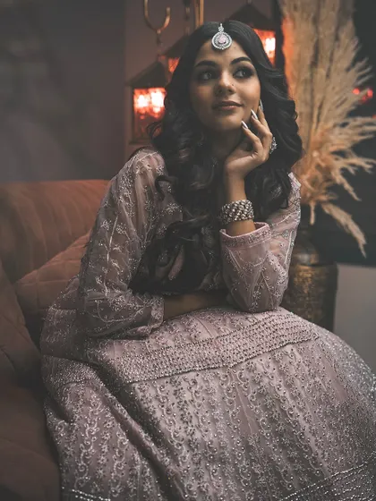 A moody, atmospheric version of a portrait from the same ethnic wear series. The warmer tones and added haze create a different, more dramatic feel.