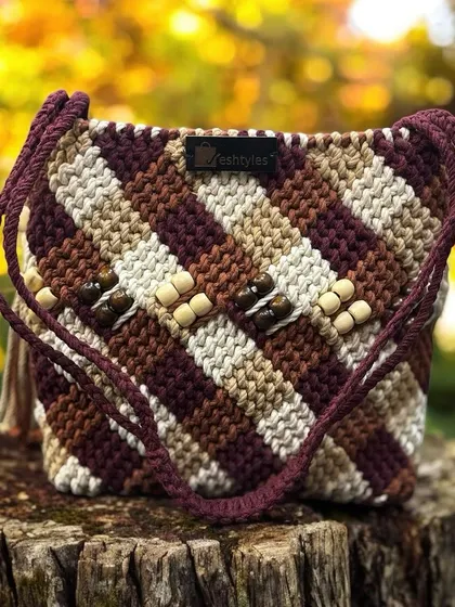 Another look at the multi-tonal beaded sling bag, sitting pretty on a tree stump. It's a true piece of wearable art.