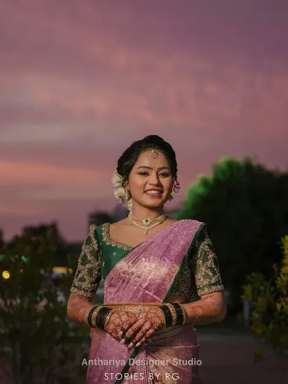 My bride Harshitha on her reception day, wearing a lovely lavender saree with a contrasting dark green embroidered blouse.