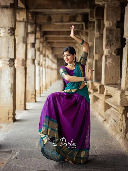 A series of photos from a collaboration with a designer, showcasing a beautiful half-saree against the backdrop of ancient temple pillars. I love how the vibrant colors of the costume stand out.