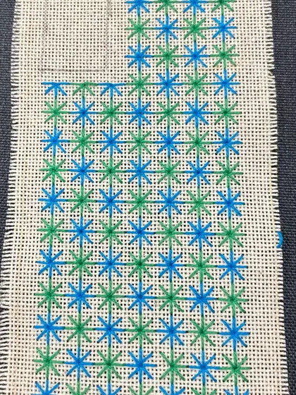 A phone insert with a star-like pattern in shades of blue and green. Each one is unique and made to order.