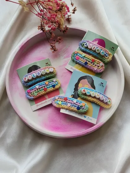 Another angle of our popular unicorn name clips, showing the vibrant colors and cute backing cards they come on.