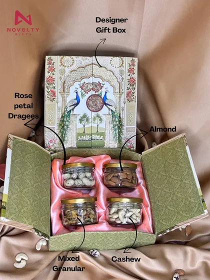 An inside look at one of my designer dry fruit boxes. This four-jar set includes almonds, cashews, rose petal dragees, and mixed granulars, all nestled in a beautiful peacock-themed box.