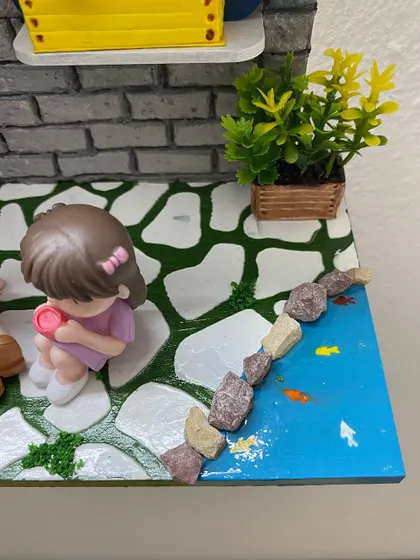 I even added a tiny shoreline with real pebbles and hand-painted fish. It’s these small, personal details that make each miniature diorama a unique piece of home decor.