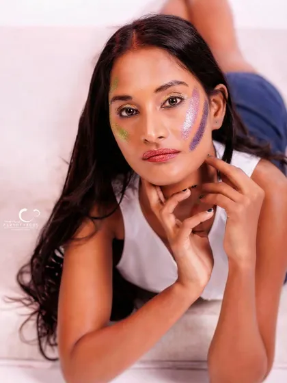 An intimate and engaging portrait. The composition is close and personal, and the glitter makeup adds a unique artistic touch.