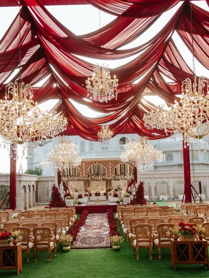 For Naomi and Rakshit's 'Laal Ishq' wedding, we created a royal atmosphere at Fairmont Jaipur. This grand setup features dramatic red draping and magnificent crystal chandeliers, embodying a timeless and luxurious Indian wedding aesthetic.