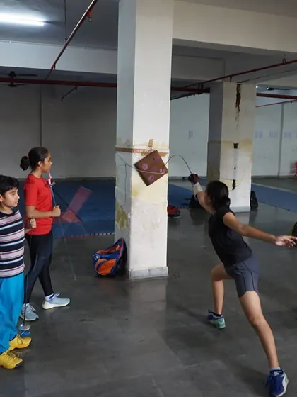 A student practices her lunge and aim by hitting a target. Target practice is an excellent way to improve accuracy and the precision of the blade tip.